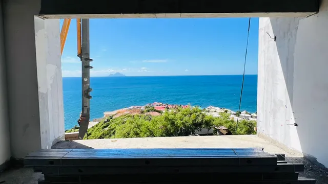 Ocean view through an unfinished window opening at the Concord construction site