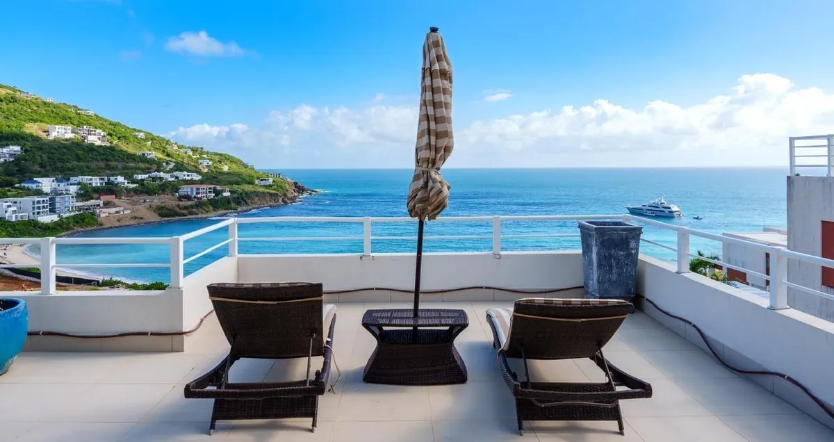 Terrace loungers facing the coastline and beach at Indigo Bay, Sint Maarten