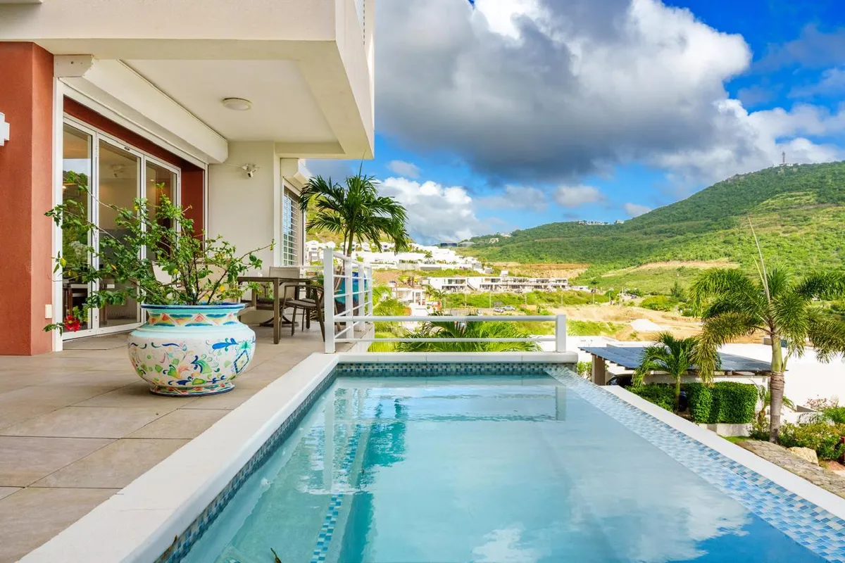 Villa plunge pool with mosaic tiles overlooking the hillside community of Indigo Bay, Sint Maarten