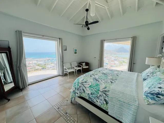Bedroom with terrace doors and a view over the bay