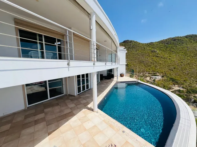 Villa Mary from above: white two-level villa with the pool terrace and hills behind